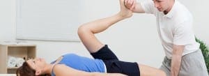 doctor stretching petient's leg